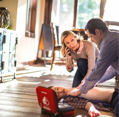 Man and Woman with Home Defibrillator.